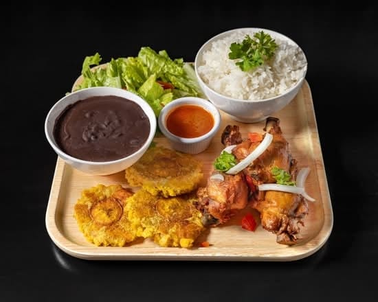 Goat in Sauce(served with plantain and 1 choice of white rice, rice and beans,  djondjon rice or  white rice and beans sauce).