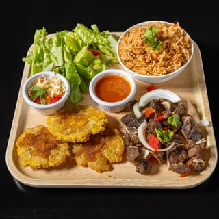 Fried Goat (served with plantain and 1 choice of white rice, rice and beans,  djondjon rice or  white rice and beans sauce)